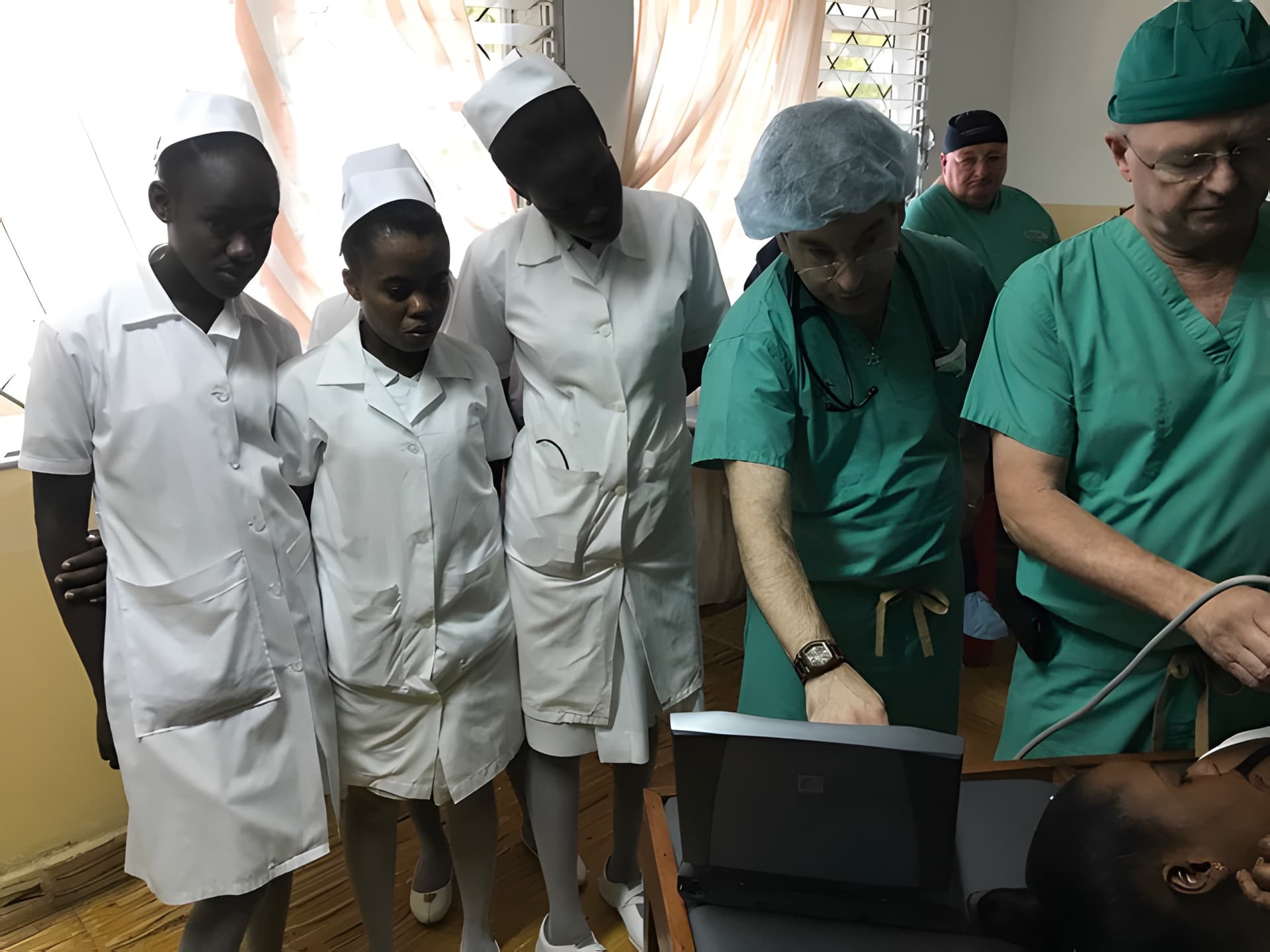 Jim and Glen showing nurses how to use portable CT scan