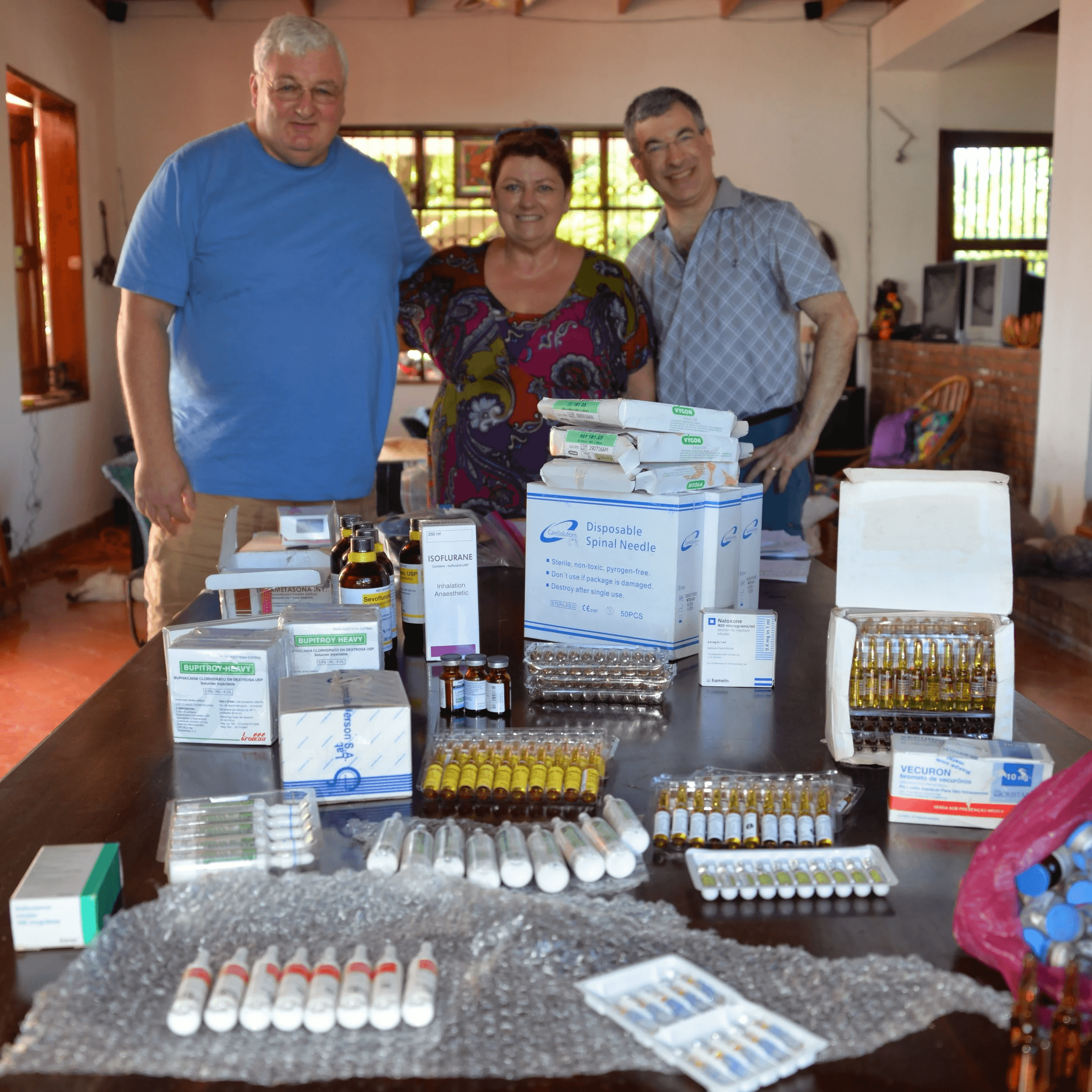 Dr. Dan Scoppetta, Bette Gebrian, RN, and Dr. Glen Rosenfield with donated surgical supplies from US